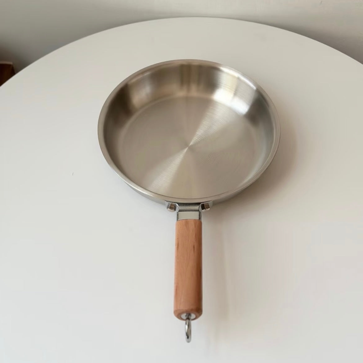 Uncoated wooden-handle frying pan