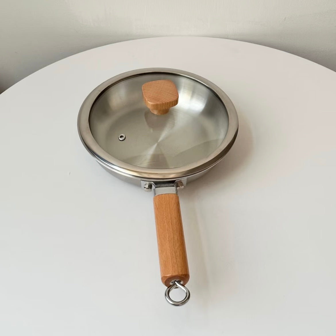 Uncoated wooden-handle frying pan