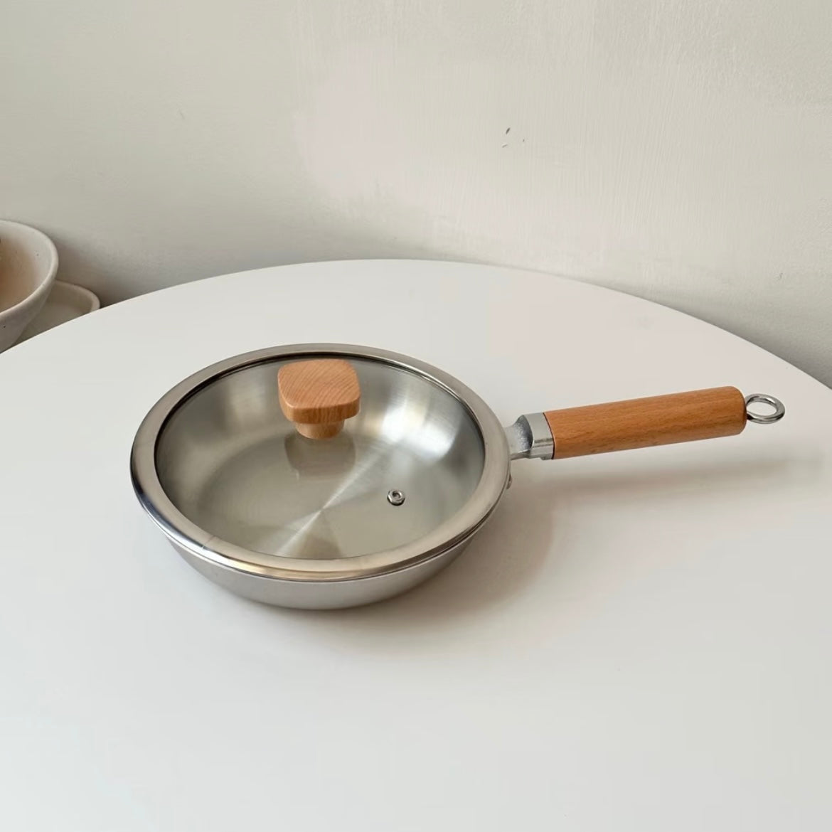 Uncoated wooden-handle frying pan
