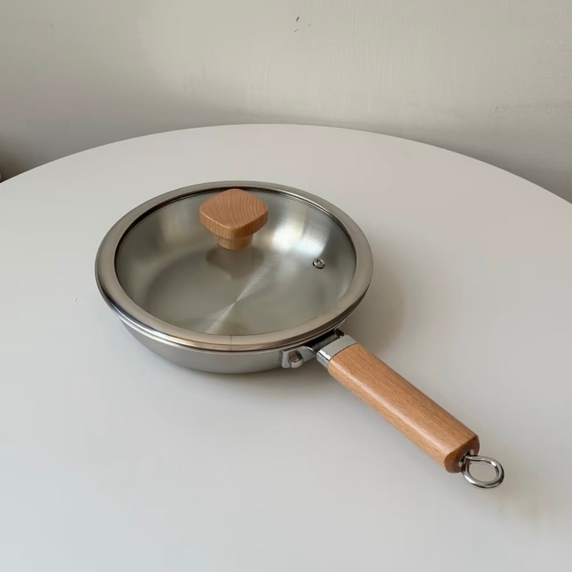 Uncoated wooden-handle frying pan