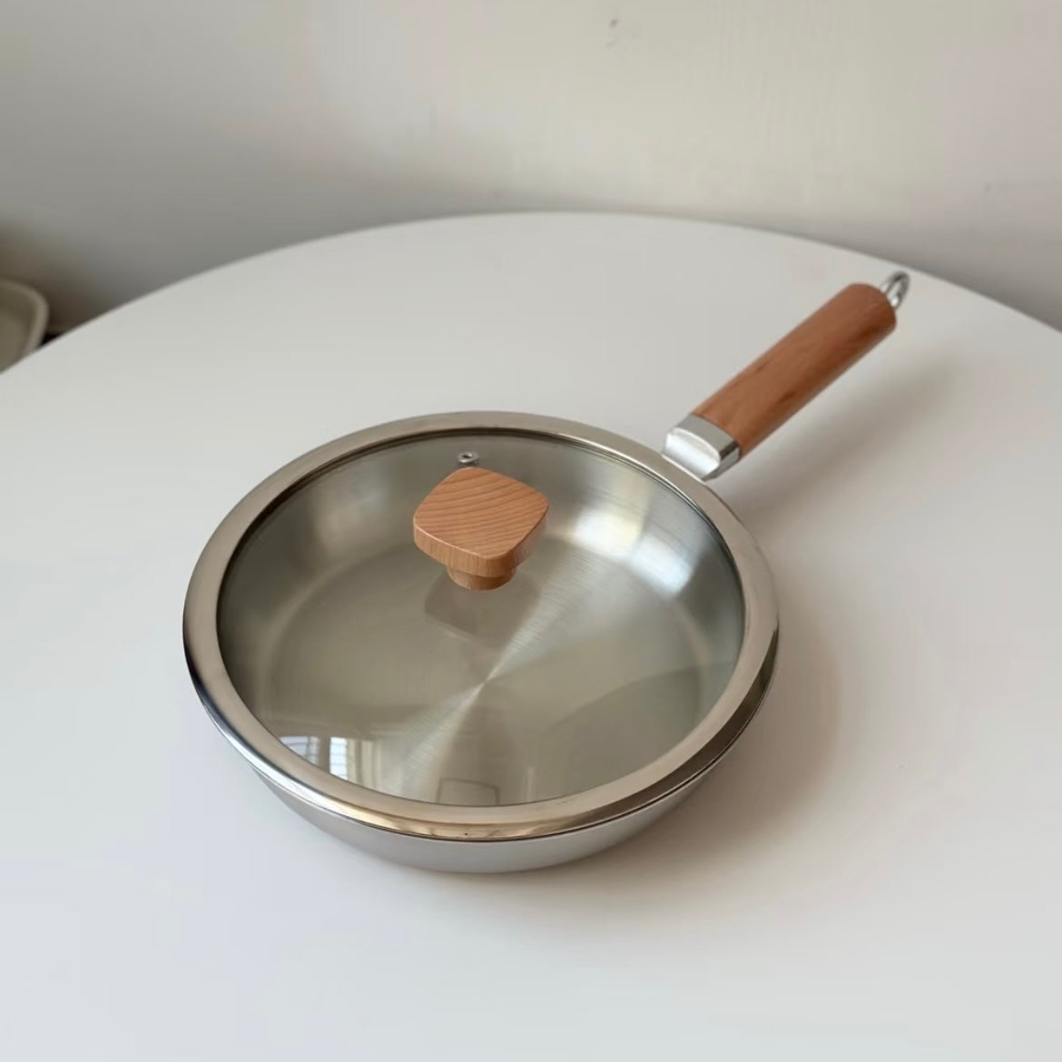 Uncoated wooden-handle frying pan