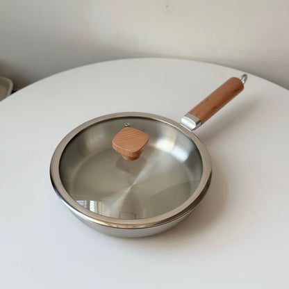 Uncoated wooden-handle frying pan